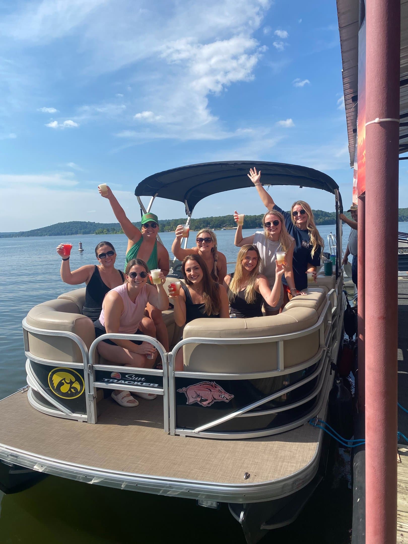 A group of friends on a pontoon at the dock